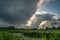 Autumn showers over the dutch polder landscape with a canal and a pumping mill