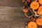 Autumn side arrangement of leaves and pumpkins over wood