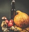 Autumn sill life - pumpkin, apples, walnuts and leaves on black background