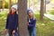 Autumn sister kid girls playing in forest trunk outdoor