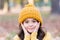 Autumn skin care. Little child wear hat on autumn landscape. Small girl touch clean pure skin. Organic cosmetics for