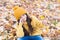 Autumn skin care routine. Kid wear warm knitted hat. Warm woolen accessory. Girl relaxing autumn nature background
