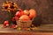 Autumn still life with apples, rowan berries, pumpkins, sunflower flowers on an old wooden table, background, Thanksgiving concept