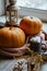 Autumn still life celebrating Halloween or Thanksgiving, ripe orange pumpkins and lantern with candles on the table near the