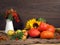 Autumn Still Life. In crop pumpkins, apples, sunflowers, branches with berries of mountain ash and ears of wheat