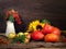 Autumn Still Life. In crop pumpkins, apples, sunflowers, branches with berries of mountain ash and ears of wheat