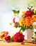 Autumn still life with garden flowers. Beautiful autumnal bouquet in vase, apples and berries on wooden table. Colorful dahlia and