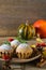 Autumn still life. Homemade cupcakes with powdered sugar with cinnamon sticks, anise stars, pumpkins, berries of rosehip and autum