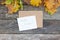 Autumn still life. Hygge style autumn flatlay composition with letter, craft envelope, blank paper card, leaves