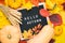 Autumn still life image with rye, pumpkins, colorful foliage and letter board with words Hello Autumn