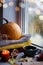 Autumn still life photography by the window, pumpkin, a cup of tea, candle