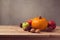 Autumn still life with pumpkin, apples and pine corn on wooden deck