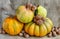 Autumn still life of pumpkins, walnuts and quince on a background of burlap.