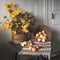 Autumn still life in a rustic retro style. Viburnum and yellow flowers in a wicker basket with apples and onions