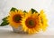 Autumn still life with sunflowers in basket. Autumn arrangement with flowers on a white wooden table