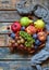 Autumn still life for thanksgiving with autumn fruits and berries on wooden background - grapes, apples, plums, viburnum, dogwood