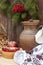 Autumn still life in Ukrainian style clay pot and autumn berry and vegetables on old wooden background, closeup