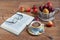 Autumn still life with various gifts of nature. Cup of tea and open book are lying on a wooden desk.