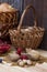 Autumn still life with walnuts and hazelnuts in the basket and autumn berry and vegetables on old wooden background, closeup