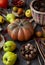 Autumn still life on a wooden table top view. Pumpkin, chestnuts, acorns, quince, nuts, cones. Rustic background. Quince and pear