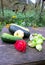 Autumn still life. Zucchini, patissons and roses, on a wet wooden table,