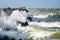 An autumn storm rages in the baltic sea, hitting the waves against a breakwater