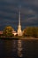 Autumn stormy sunset with dark clouds in front of Peter and Paul fortress