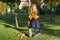 Autumn sunny park, little girl with a bouquet of yellow maple leaves, copy space