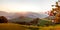 Autumn sunset panorama in the austrian alps shining at an alpine meadow at the mountains in styria