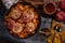 Autumn sweet dish baked apples and pumpkin in a frying pan with honey on rustic background. Top view