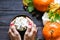 Autumn sweet hot drink. Female hand holding traditional latte cup in hands, on rustic wooden background. Concept holiday.