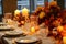 Autumn table setting with candles, pumpkins and flowers. Thanksgiving table decoration