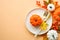 Autumn table setting. White plate, golden cutlery and fall decorations.