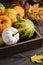 Autumn Thanksgiving Composition with Assorted Mini Pumpkins in Wooden Tray on a Wooden Table