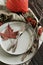 Autumn Thanksgiving dinner table setting with pumpkins, fallen leaves and vintage cutlery top view