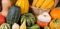 Autumn Thanksgiving motive with a basket full with corn cobs and different colorful pumpkins