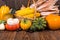 Autumn Thanksgiving motive with a basket full with corn cobs and different colorful pumpkins and chestnuts on an old rustic wooden