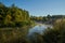 Autumn time. Dawn over the river in a misty, brooding haze. Beautiful view of the forest and river, covered with fog in the early