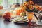 Autumn traditional seasonal table setting at home with pumpkins, candles and flowers