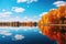 Autumn tranquil lake with beautiful Fall foliage and blue sky. Autumn seasonal concept.