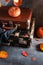 Autumn travel concept. Vintage old fashioned Suitcases with pumpkins and autumn leaves on dark background. Copy space