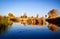 Autumn tree reflection in water of marsh in mountain valley wetlands