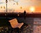 Autumn  tree yellow  leaves fall ,people on city observation balcony in park relaxing   and watch  evening sunset in Tallinn Eston