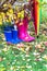 Autumn. Two pairs of rubber boots and colorful umbrella with autumnal leaves.