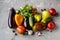 Autumn vegetables bell pepper, eggplant, tomatoes, garlik, cucumbers on a grey grundge background