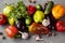 Autumn vegetables bell pepper, eggplant, tomatoes, garlik, cucumbers  on a grey grundge background