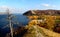 Autumn view of a dried pine tree, the slope of Mount Mogutovaya, Mount Lysaya in the background and the Volga River.