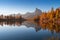 Autumn view of Lake Federa in Dolomites at sunset. Fantastic autumn scene with blue sky, majestic rocky mount and colorful trees