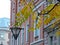 Autumn view of street in Saint-Petersburg with lantern, rowan tree and old house