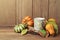 Autumn wallpaper with candle, pumpkin decorations and fall leaves. Thanksgiving table